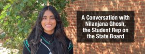 Featured image of student rep Nilanjana Gosh smiling with a brick wall behind her