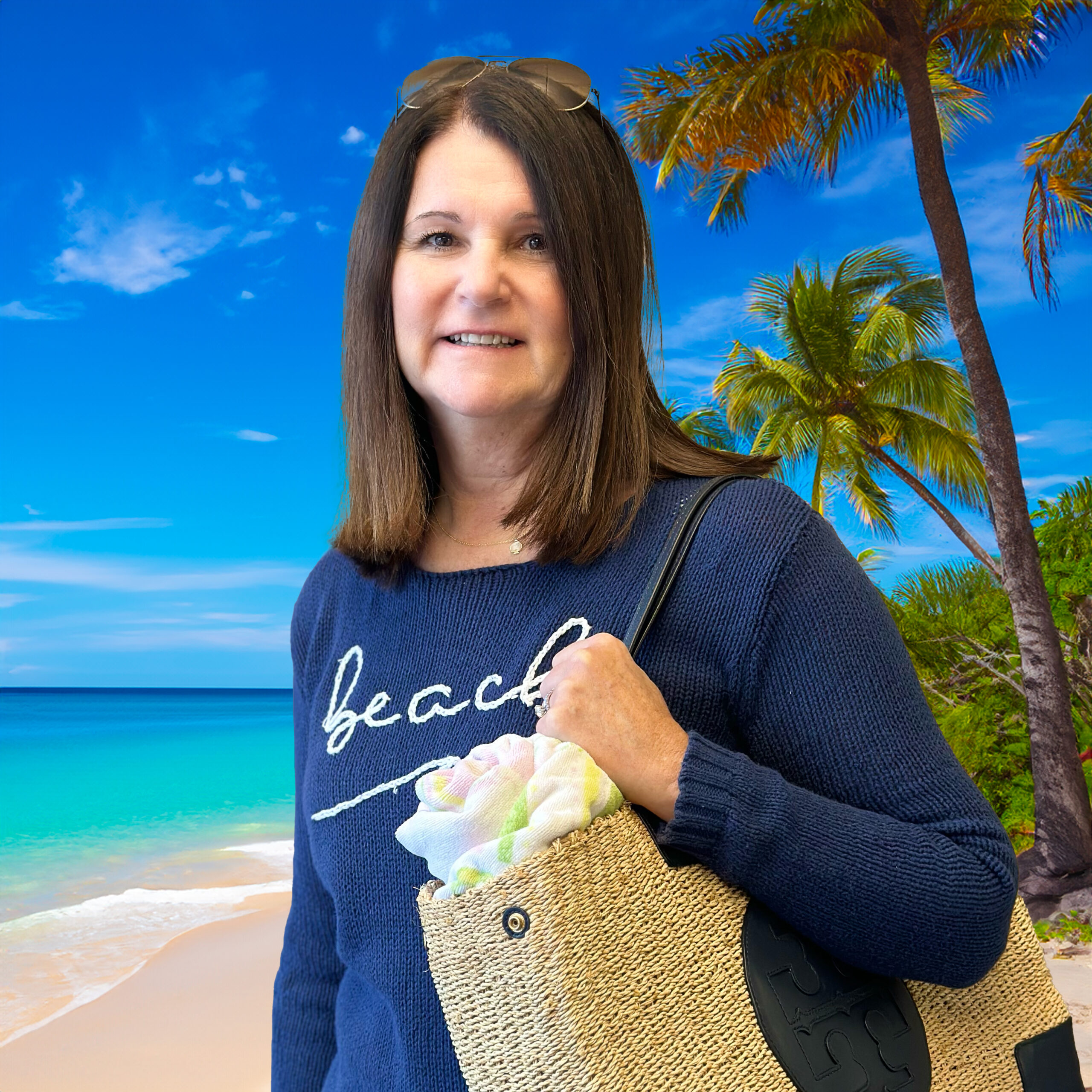 Karen Callahan posing with a beach bag and a tropical beach in the background