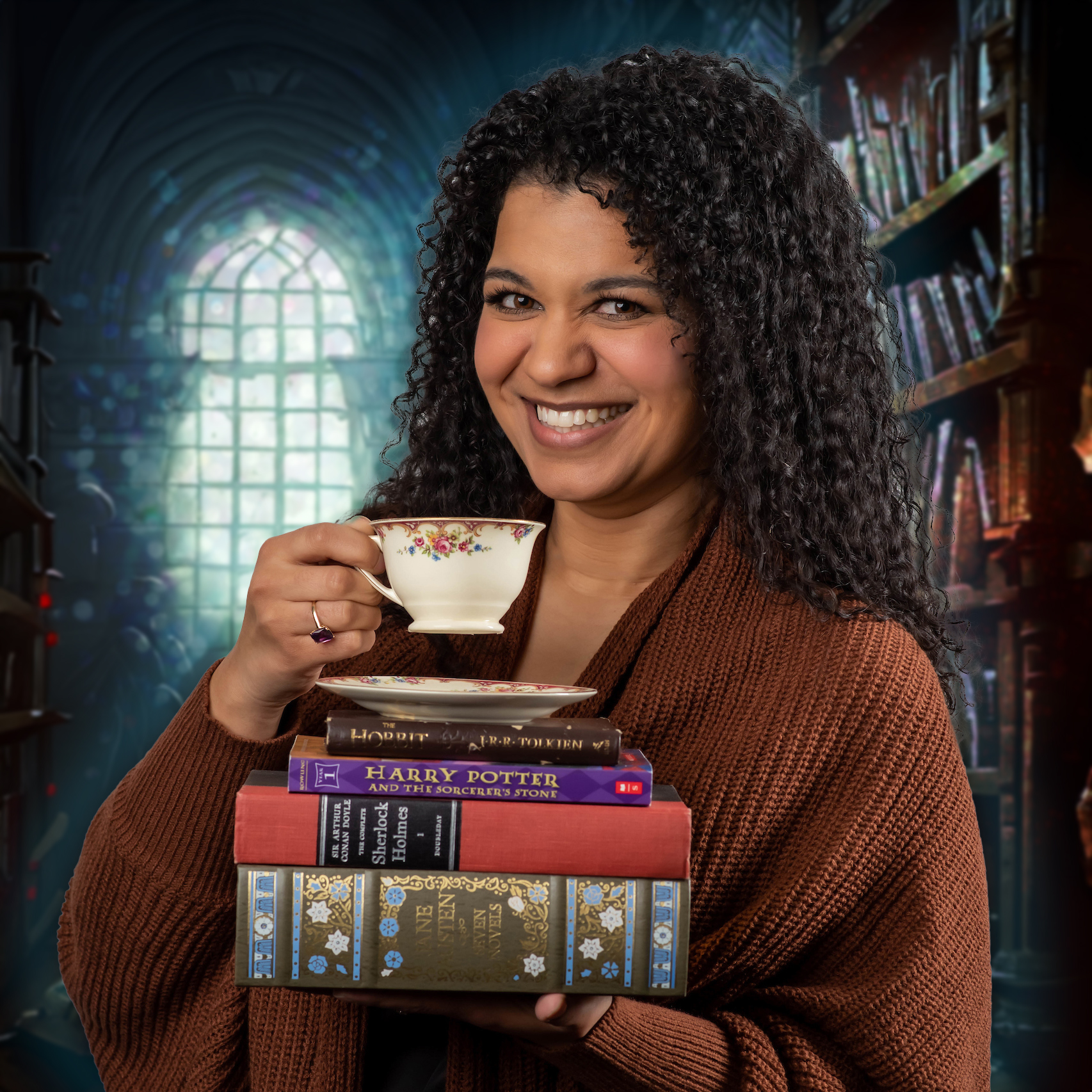 Lucia Gershman fun photo posing with Harry Potter books and a cup of tea with a mystical library in the background