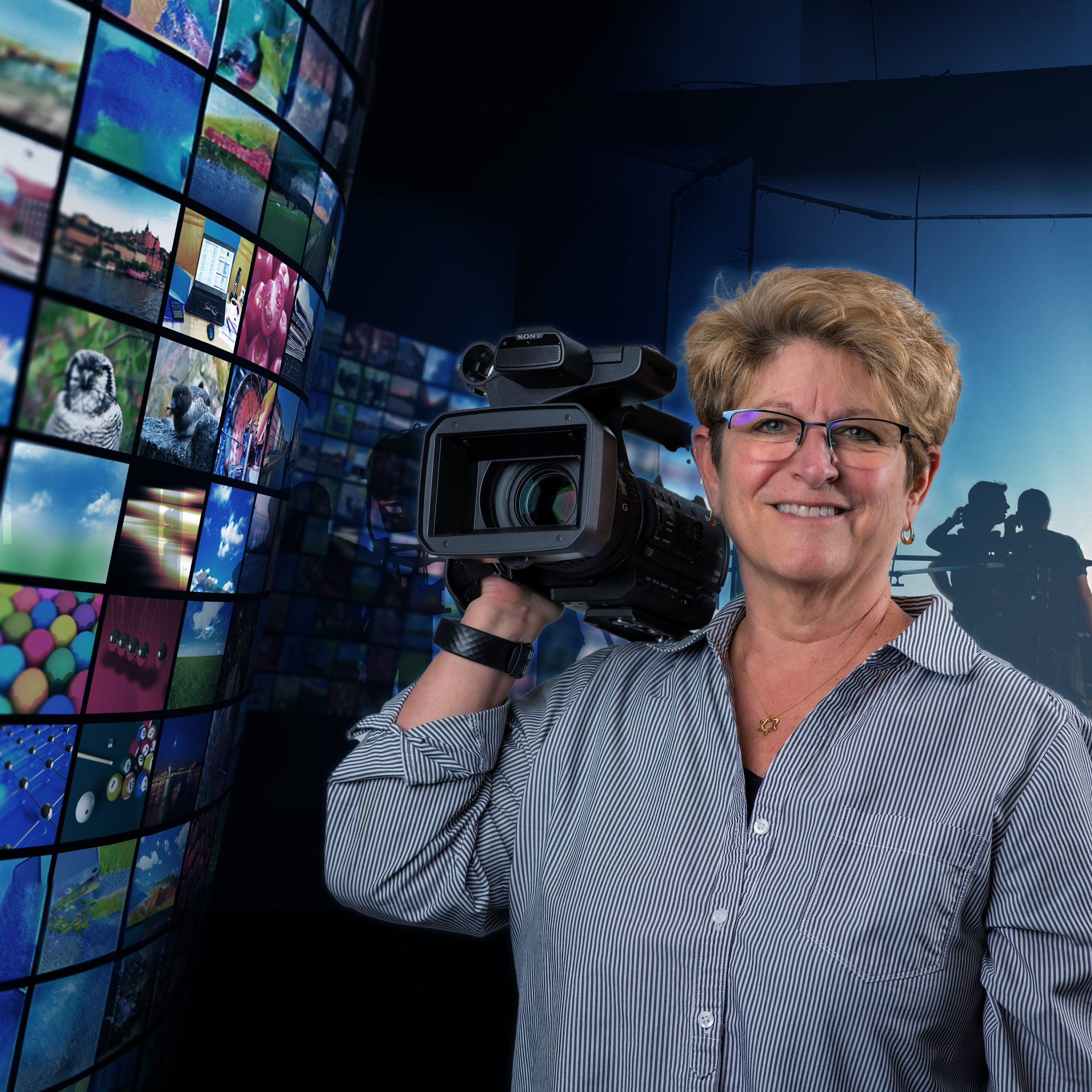 Robin Kampf holding movie camera in front of production set team and video reel screen