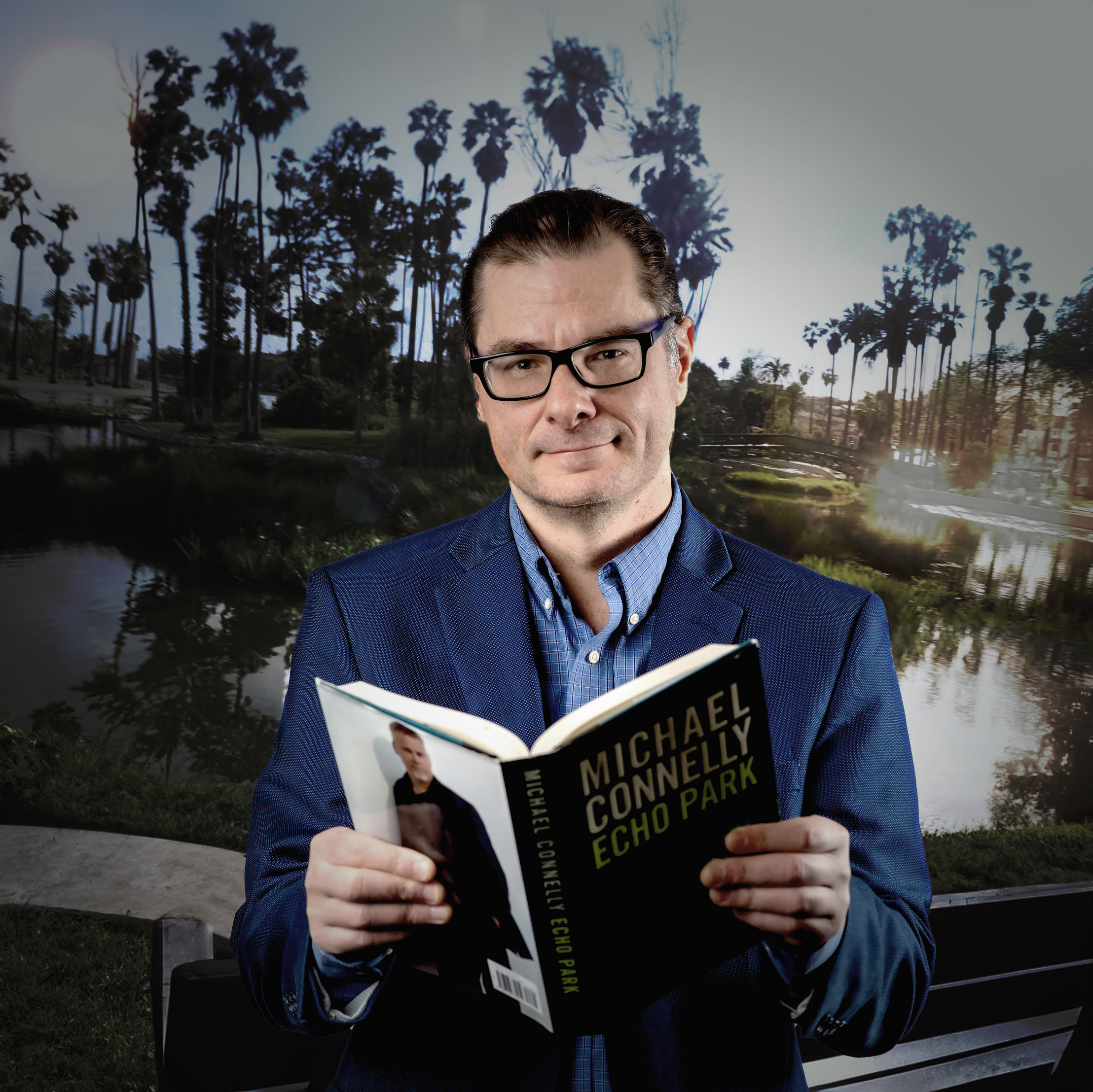 Thomas Parmalee reading a thriller book in front of mysterious park lake with trees