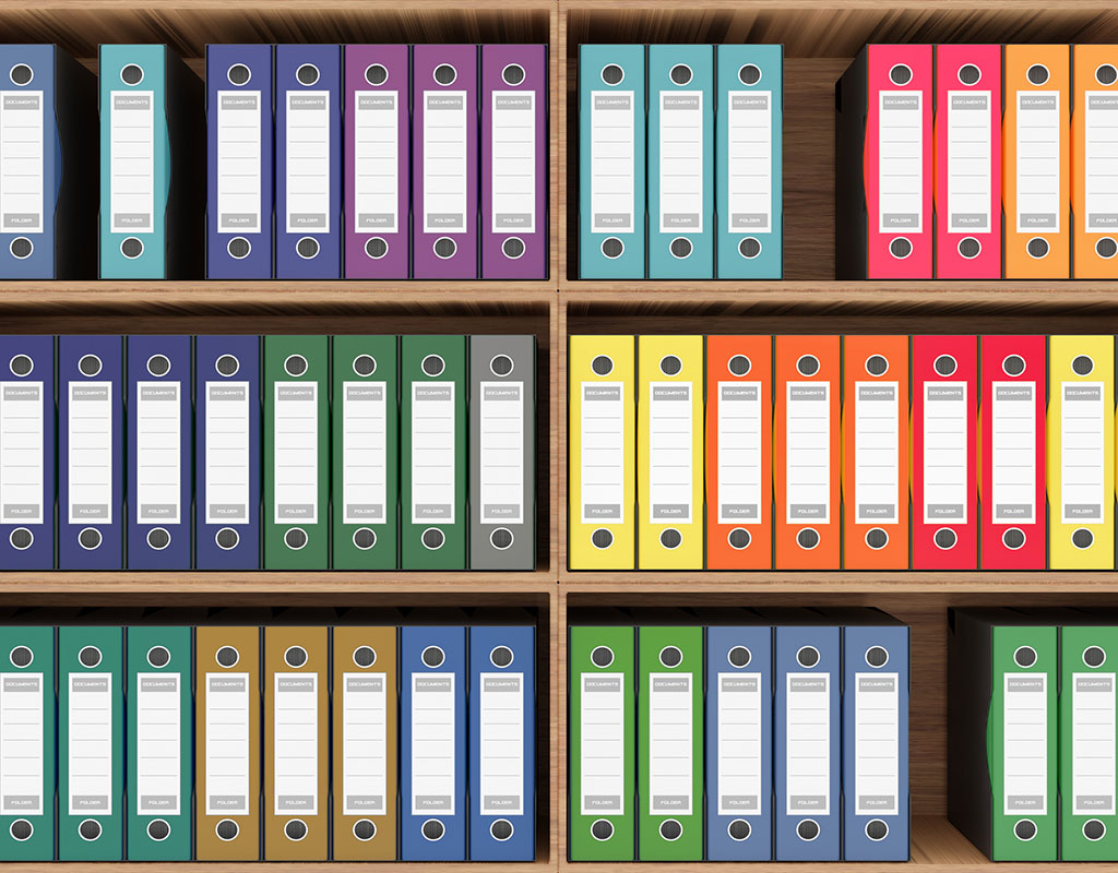 colorful binders on a bookshelf