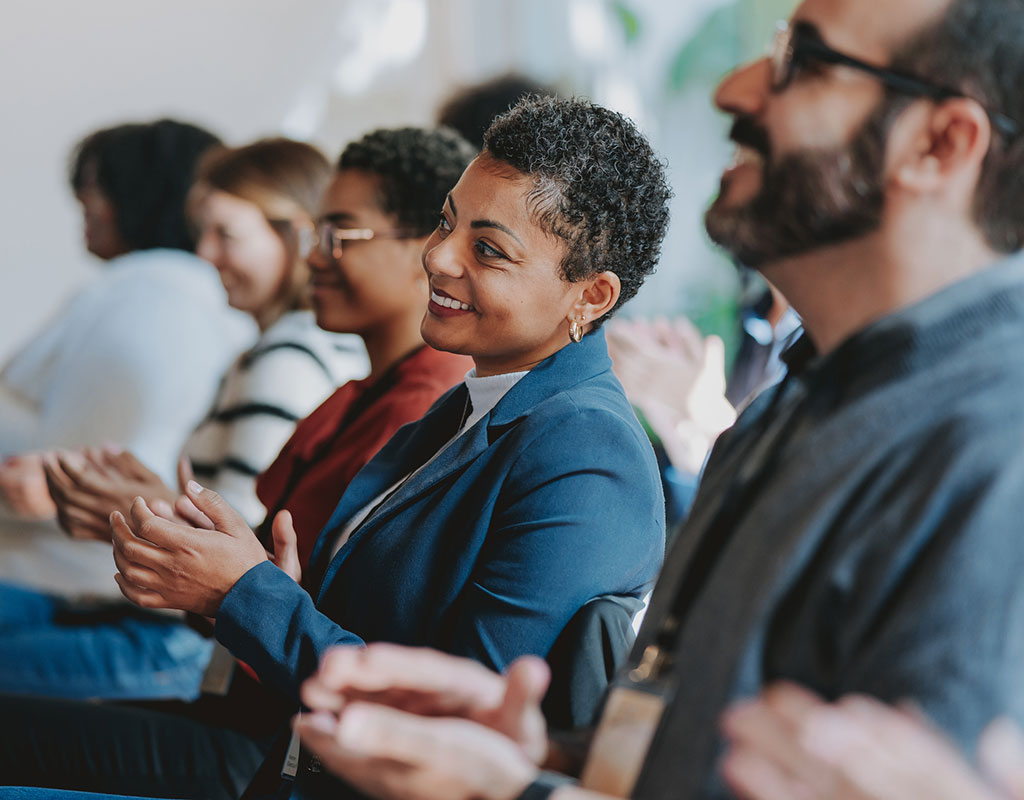 Group of diverse people smiling and clapping