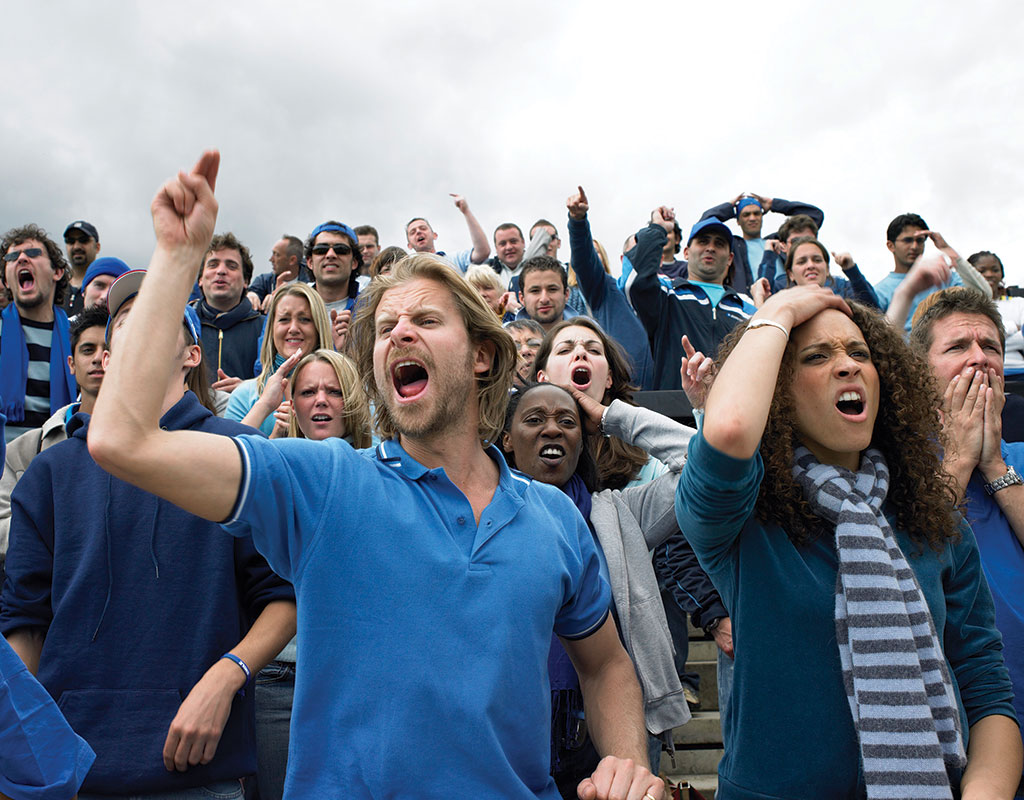 Rowdy crowd of mixed people at high school stadium