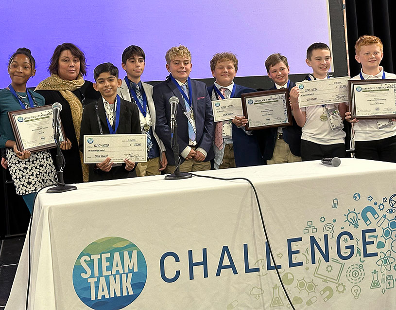 STEAM Tank student winners pose with their certificates and jumbo prize checks